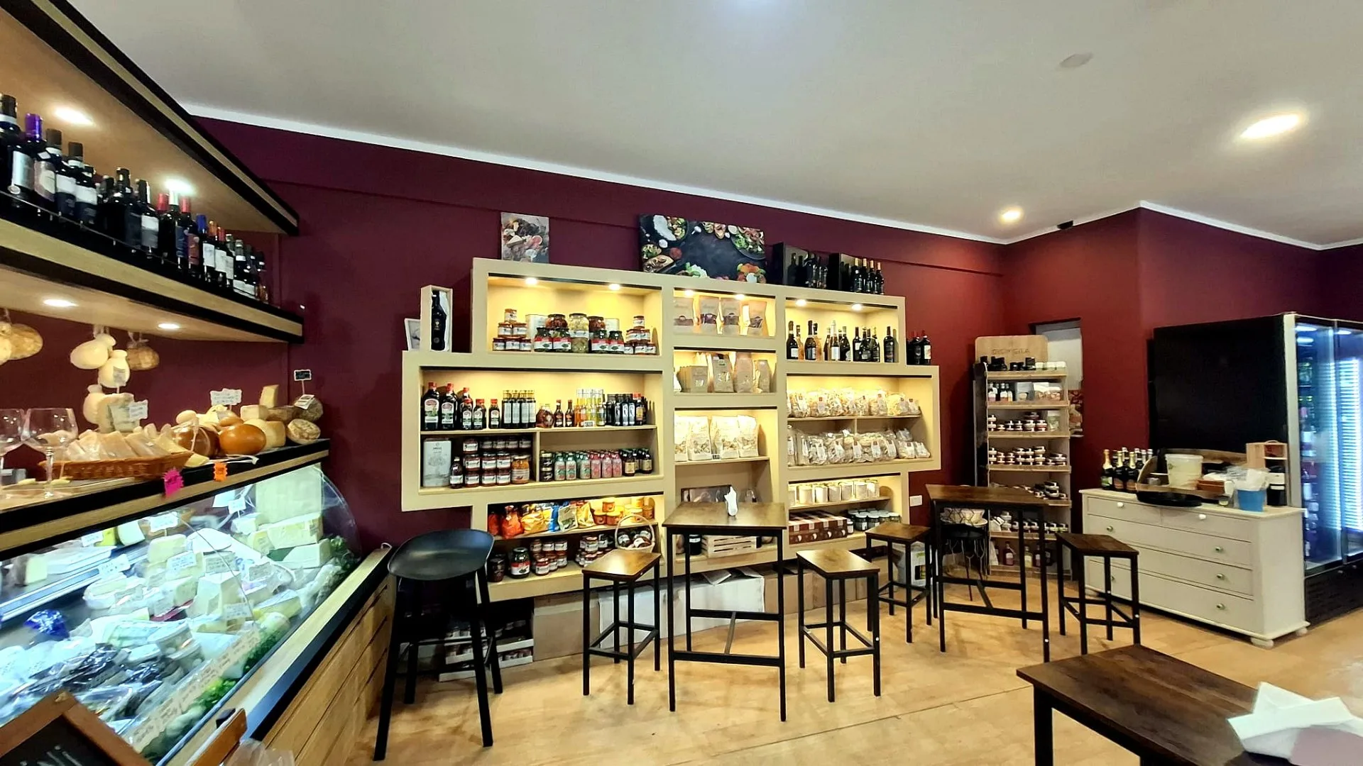Interior of Origini Salumeria in Swieqi with shelves of Italian wine, pantry goods and the cheese counter